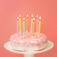 Load image into Gallery viewer, Lit pastel twisted birthday candles on a pink frosted cake with sprinkles, set against a soft pink background – elegant and fun cake decoration for parties