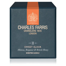 Load image into Gallery viewer, Charles Farris Sweet Elixir scented candle packaging box, featuring a dark slate blue exterior with a vertical orange stripe and cream-colored text and crest logo.