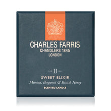Load image into Gallery viewer, Charles Farris Sweet Elixir scented candle packaging box, featuring a dark slate blue-gray background with an orange vertical banner and white text.