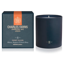 Load image into Gallery viewer, Charles Farris Sweet Elixir scented candle in a matte navy blue jar next to its dark teal packaging box with an orange accent stripe.
